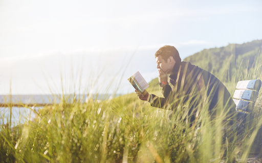Man sitting reading a book from Chrome web store to be run with OffiDocs Chromium online Man sitting reading a book from Chrome web store to be run with OffiDocs Chromium online